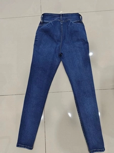 Detailed back view of high-stretch blue skinny jeans with wide waist and clear stitching
