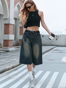 Street style shot of dark grey washed wide-leg denim culottes with high-waist vintage finish