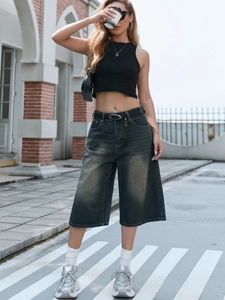 Detail of dark blue vintage wash denim wide-leg pants with classic five-pocket design