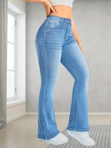 Close-up of high-waist light blue flare jeans with subtle faded wash and vintage denim detail
