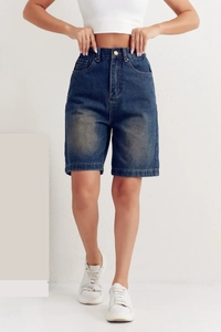 Detail view of high-waisted dark blue washed denim bermuda shorts with elastic waistband
