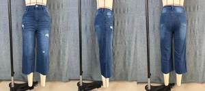 Detailed views of high waist distressed denim jeans with frayed hems and cat whiskers washing