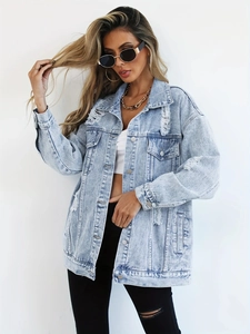 Oversized light blue washed denim jacket with trendy distressed ripped details and metal buttons