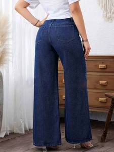 Detail of classic back pocket stitching on high-waist deep blue wide-leg denim jeans