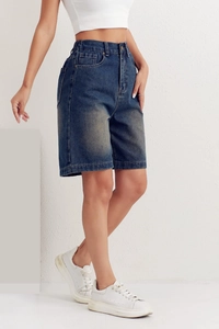 Detailed view of high-waisted medium blue denim bermuda shorts with casual straight fit