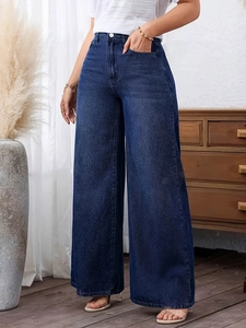 Detail of high waisted wide leg jeans in dark blue wash with a relaxed vintage fit