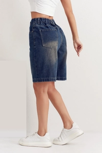 Detailed back view of mid-blue denim shorts featuring elastic waist and wash texture
