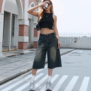Women's streetwear outfit featuring high waist vintage wide leg denim capri pants and belt