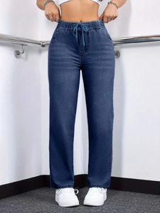Detail of high-waist straight leg jeans with elastic drawstring waist and side pockets