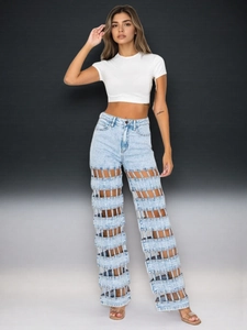Detailed view of high-rise light wash denim jeans with unique horizontal cutout design