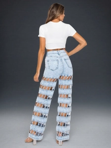 Detail view of high-waist wide-leg jeans with unique hollow out cutouts on the back leg