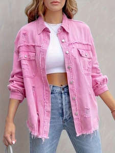 Detail of pink distressed denim jacket with metal buttons and frayed edges on hemline