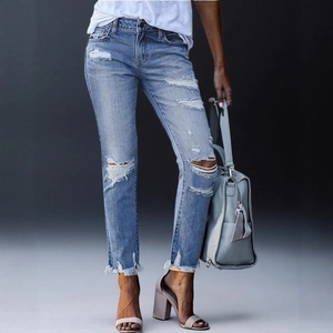 Eng geschnittene hellblaue Cropped-Jeans mit Distressed-Details und Fransensaum