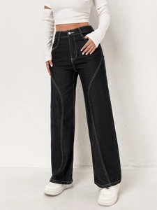 Macro detail of high-waist black cargo jeans with distinctive white contrast stitching