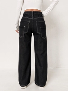 Detail view of black high waist wide leg jeans with white contrast stitching and pockets