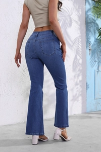 Detail view of the slimming back pockets and lift design on dark blue flared jeans