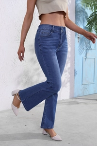 Detail of slim fit flare jeans showing vintage faded wash and blue denim texture