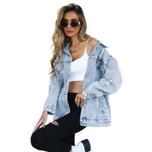 Distressed oversized light blue denim jacket with vintage wash and ripped details