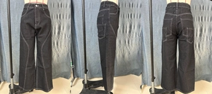 Detail view of high-waist wide-leg cargo jeans with contrast white stitching and side pockets