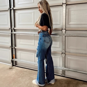 Women's high waist flared jeans in dark blue wash with trendy distressed side cutouts