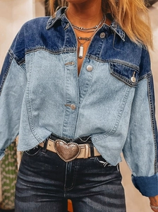 Detail of color-block patchwork denim jacket featuring raw hem and vintage metal buttons