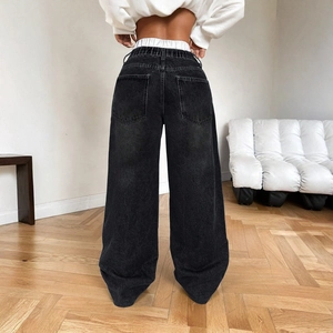 Back view of loose wide-leg low-rise denim jeans in dark grey with elastic waist design