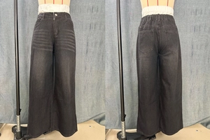 Detail view of high-waist wide-leg jeans in dark grey with whiskered wash and elastic waist