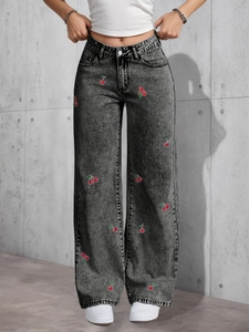 Detail of red cherry embroidery on retro black washed high waist wide leg denim jeans