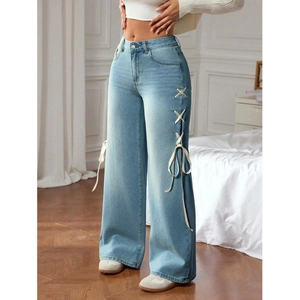 Light blue high waist wide leg jeans featuring elegant white ribbon side lace-up details