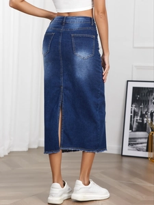 Rear view of a high-waisted dark blue denim skirt with a back slit and frayed hem