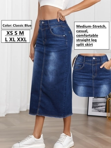 Detail of classic blue denim skirt showing high waist cut and slit hem with fraying