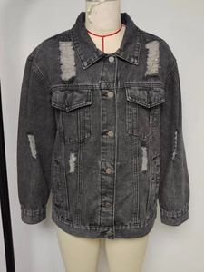 Detailed view of oversized distressed denim jacket with vintage ripped effects and pockets