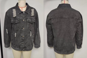 Macro detail of distressed denim jacket featuring heavy washing and ripped hole textures