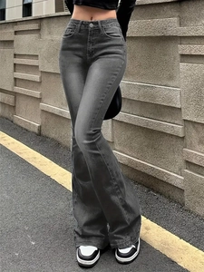 Close-up of low-rise flared jeans featuring washed denim fabric and whisker texture details