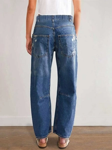 Detail view of elastic waist and distressed back pocket on blue wide-leg jeans