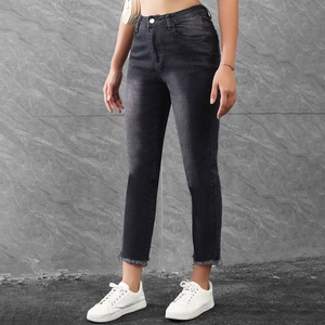 Detailed close-up of frayed raw hems on high-waisted slim fit black cropped jeans