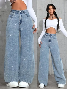 Detail of high waist wide leg jeans in light blue denim with silver rhinestone embellishments