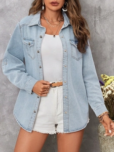 Close-up of light blue denim shirt with chest pockets and button-down collar detail