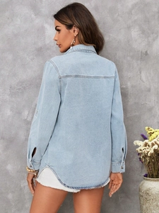 Rear view of a light blue denim shirt featuring classic back yoke stitching and curved hem