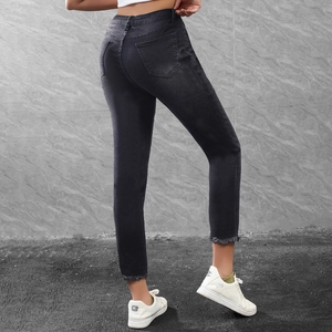 Women's black cropped skinny jeans with frayed hems and high-stretch denim back view