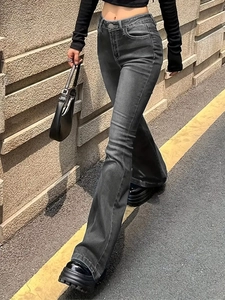 Detail of high-waist flared jeans in dark grey wash featuring a vintage distressed effect