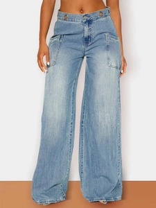 Detail of high-waisted wide-leg jeans in light blue with metal eyelet waist decoration