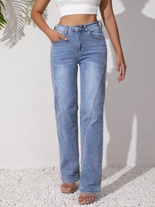 Detail of light blue straight-leg jeans with unique V-shape stitching on the front leg