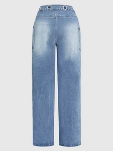 Detail of light blue wide-leg jeans featuring metal eyelet waist and washed denim texture