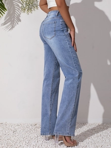 Close-up of light blue high waist jeans showing slim fit rear and dual back pockets