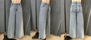 Detailed views of light blue wide-leg jeans with rhinestone accents on denim fabric