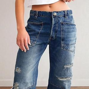 Women's high waist wide leg jeans with distressed patchwork and cargo pockets in blue
