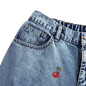 Light blue wash denim pants with red cherry embroidery and elastic waist detail