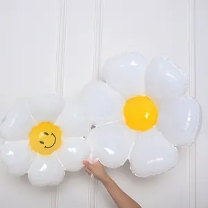 Macro detail of white daisy foil balloon set with a smiley face for party decoration