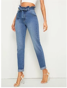 Detail of light blue high waist paperbag jeans with denim bow tie and ruffled waistband